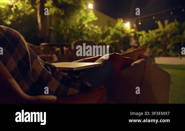 Relaxed Remote Worker Resting Outdoors at Night With Laptop on Lap in ...