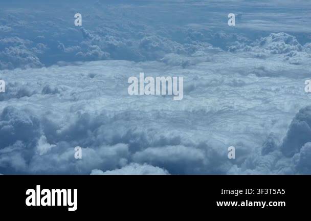 Smooth forward tracking shot looking down at dense solid sea of fluffy ...