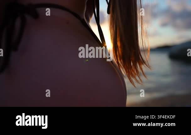 Close up Of A Young Womans Back Wearing A Bikini She Is Standing On close-up-of-a-young-womans-back-wearing-a-bikini-she-is-standing-on