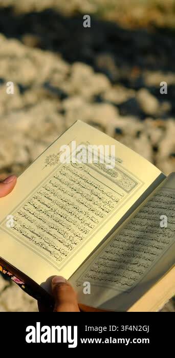 Young Man Read Quran Outdoors Verses Of The Quran With The Meaning In young-man-read-quran-outdoors-verses-of-the-quran-with-the-meaning-in