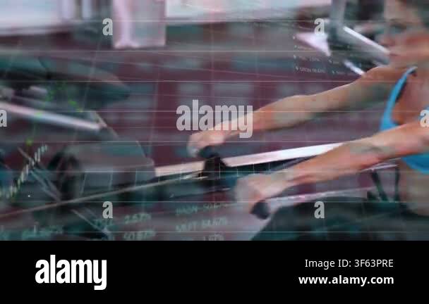 Vertical video: Camera pulling back showing woman rowing erg at gym ...