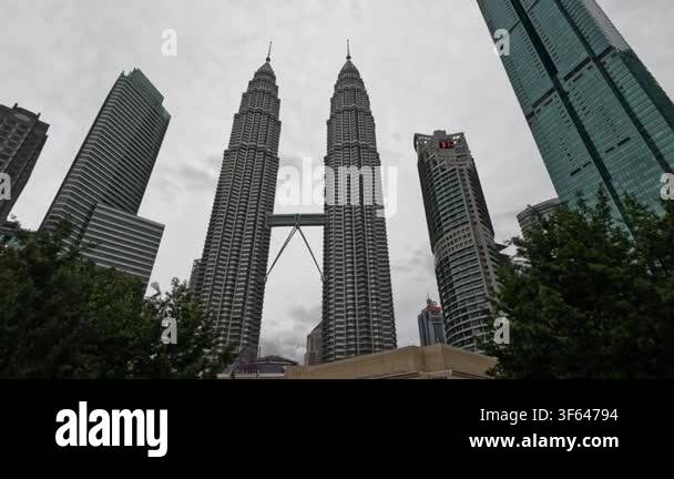 wide-shot-of-the-petronas-towers-and-surrounding-skyscrapers-in-kuala-lumpur-on-a-cloudy-day-showcasing-the-iconic-towers-and-urban-skyline-3f64794.jpg