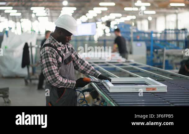 Professional african american male worker wearing a hard hat assembling ...