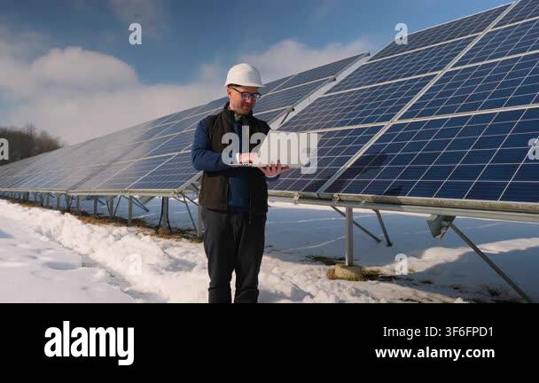 Professional engineer in a hard hat working with a laptop, performing ...