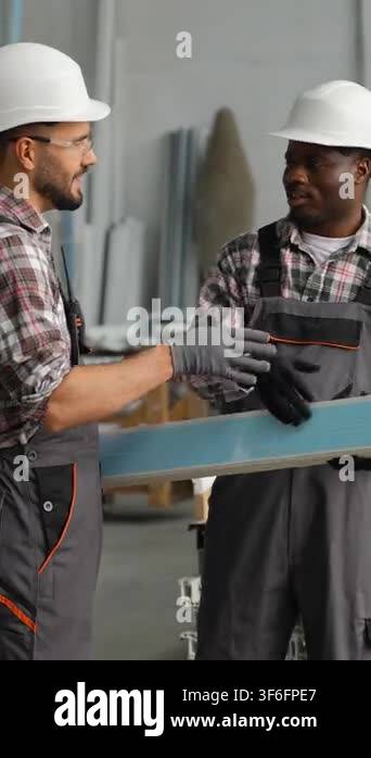 Professional diverse male employees in hard hats and uniforms ...