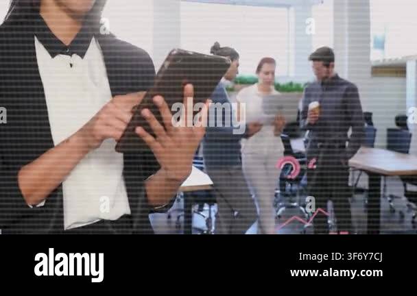 Woman tapping tablet in office generating business charts and rings ...