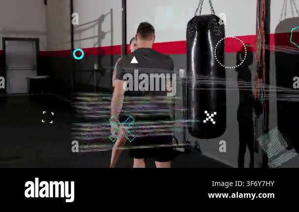 Coach shifting heavy bag nudging gloved trainee punching for boxing ...