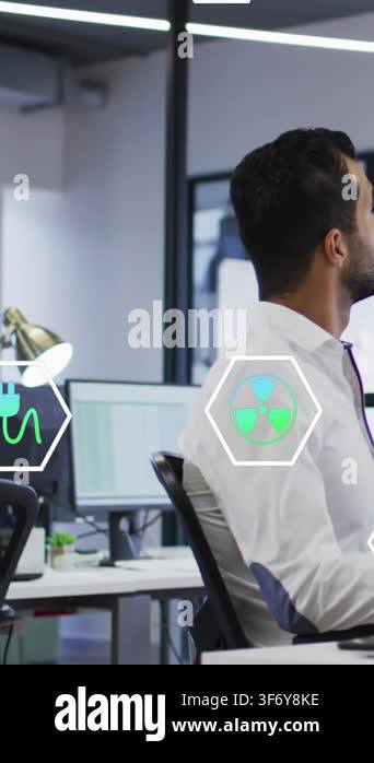 Vertical video: Man shifting and speaking at desk with hex icons ...