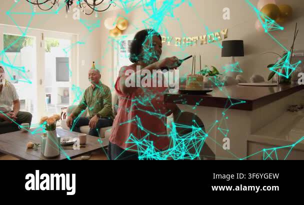 Senior woman lighting candles walking and presenting cake for birthday ...