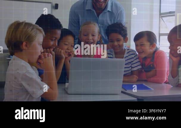 Students around laptop, smiling as laptop playing clip, teacher leaning ...
