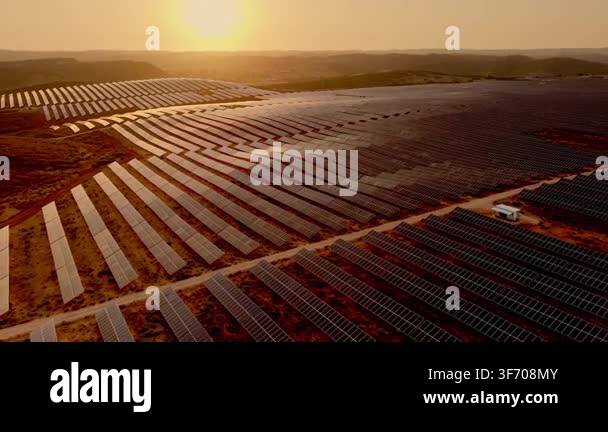 Aerial panoramic view of extensive photovoltaic arrays covering rolling ...