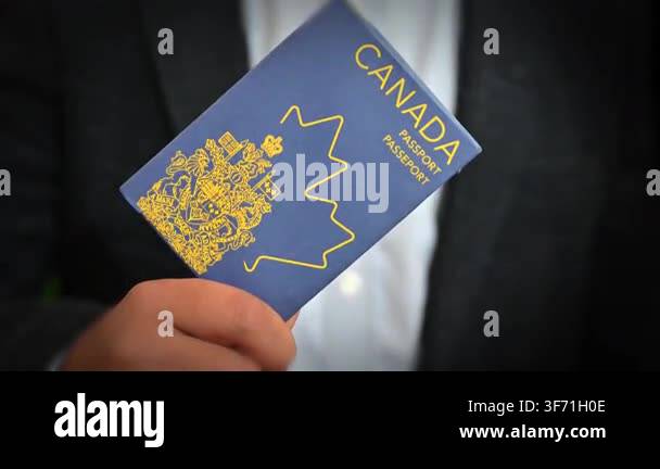 Close-up of Canadian passport held in hand highlighting cover design ...