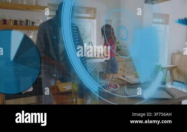 Man chopping in kitchen while woman washing produce for meal, HUD ...