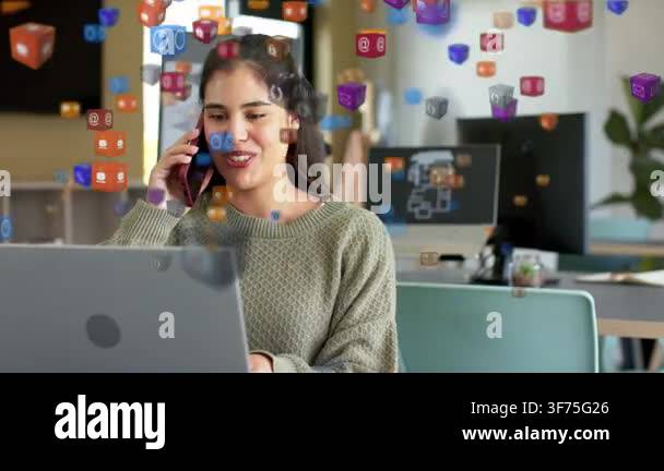 Woman on phone typing at laptop, icon cubes appearing and drifting ...