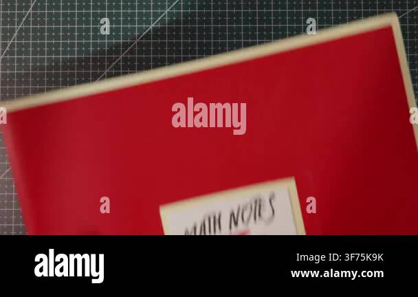 Horizontal flat lay perspective displaying a red folder journal with a ...