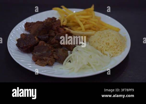 Slow motion camera panning of traditional kazan kebab with roasted meat ...