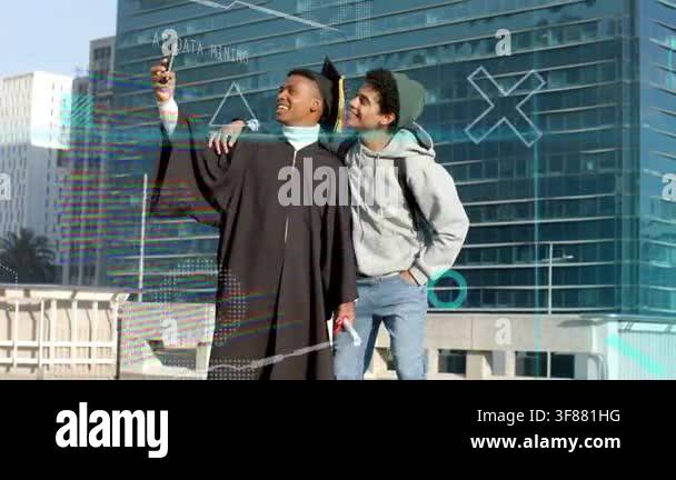 Grad lifting phone for selfie, friend leaning in for graduation while ...