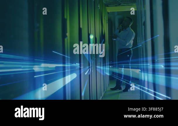IT technician receiving call and fixing server racks while blue streaks ...