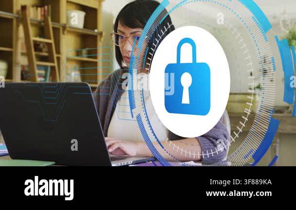 Teen typing at laptop at home desk, padlock HUD appearing obscuring ...