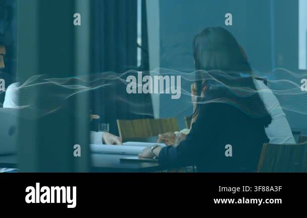 Business team reviewing papers, colleague pointing, initiating ...