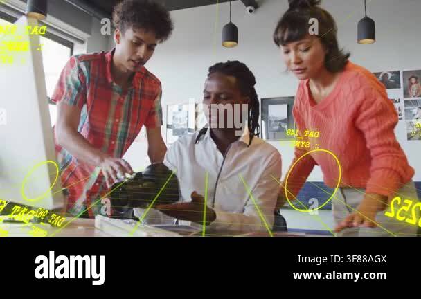 Seated man lifting device using keyboard, team pointing, yellow ...
