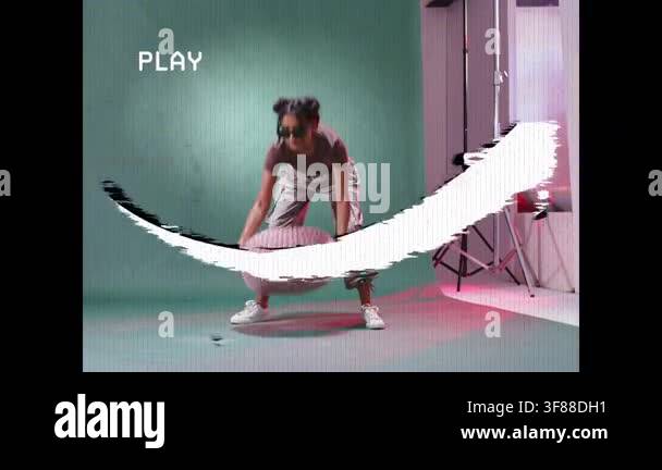Model entering with pouf placing posing on green set for shoot while ...