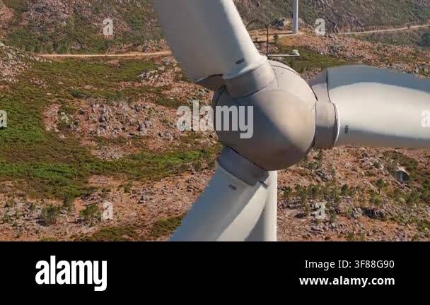 Detailed close view of a wind turbine nacelle, hub and blades above ...