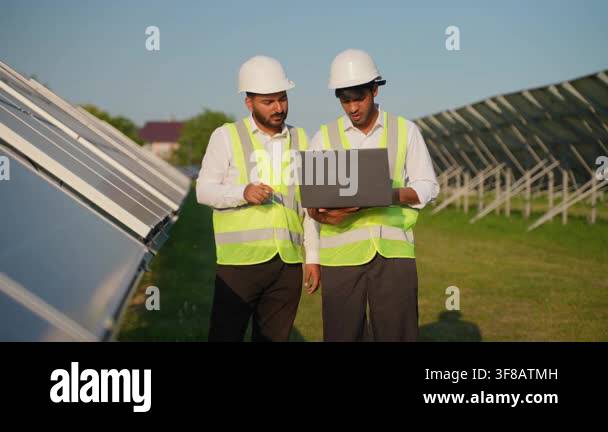 Two diverse electrical engineers in hard hats and safety vests ...