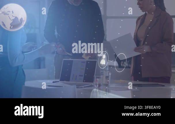 Team leaning around table, man using pen on laptop starting overlaying ...