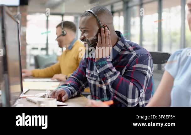 Man adjusting headset, answering call, typing and clicking mouse to ...