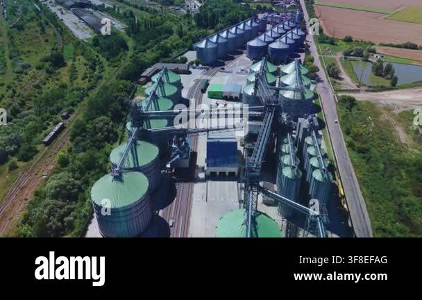 Dynamic high angle overview captures rows of steel grain silos with ...