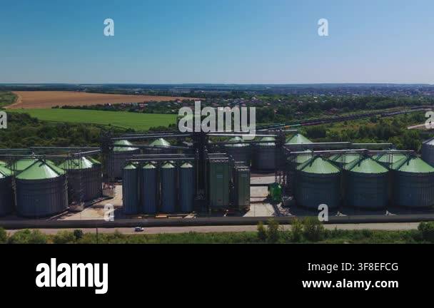 Dynamic aerial overview displays modern metal grain elevator complex ...