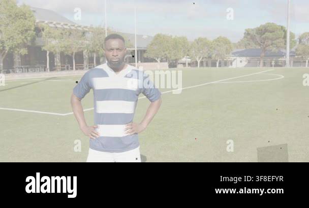 Male athlete seeing camera, near posts, stepping forward, crossing arms ...