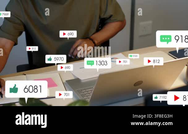 Vertical video: Man writing flipping charts and using laptop as badges ...