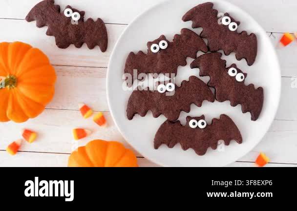 Plate of chocolate Halloween bat cookies. Slow rotating zoom motion ...