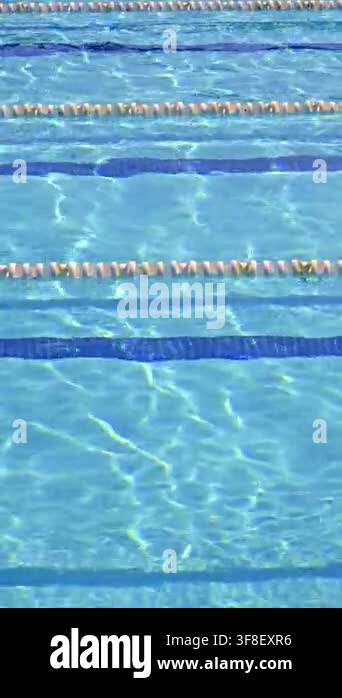 Crystal clear blue water in a swimming pool gently rippling in the ...