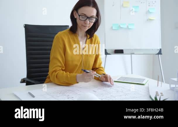 Woman architect focusing on architectural designs, developing precise ...