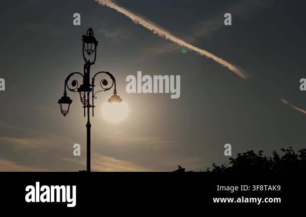 Creative perspective of dark lantern silhouette lit by natural sunshine ...