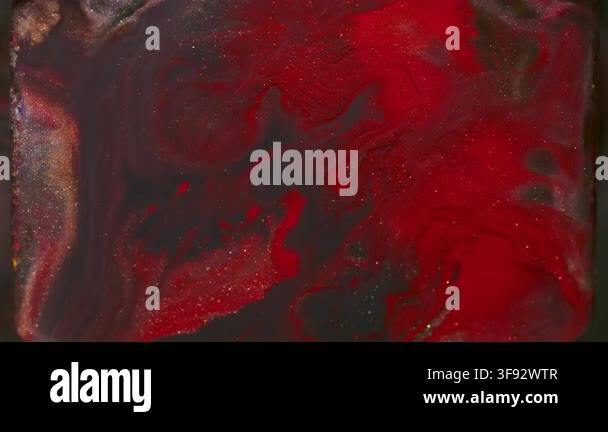 Shimmer paint. Pigment splatter. Defocused red orange purple color ...