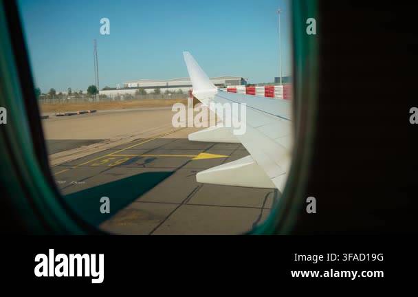 passenger-view-through-airplane-window-during-pushback-from-airport