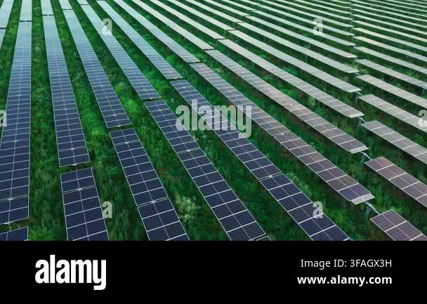 Expansive solar farm with long parallel photovoltaic panel rows across ...