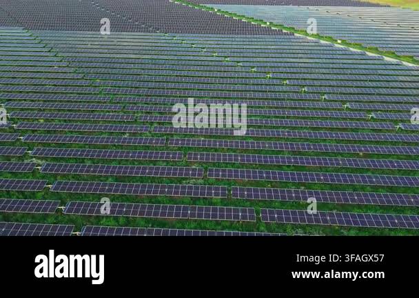 Aerial view of a vast utility-scale solar farm with dense photovoltaic ...