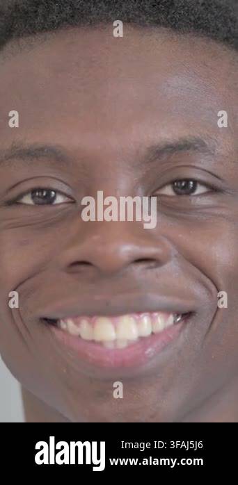 close-up-of-smiling-young-african-man-face-vertical-video-stock-video