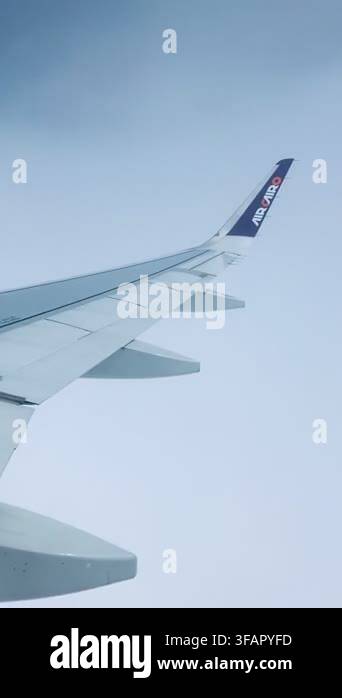 View From The Airplane Window To The Wing And Clouds At Sunrise Blue view-from-the-airplane-window-to-the-wing-and-clouds-at-sunrise-blue