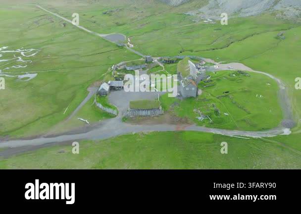 an-aerial-drone-tracking-shot-pans-left-over-a-historic-viking-village