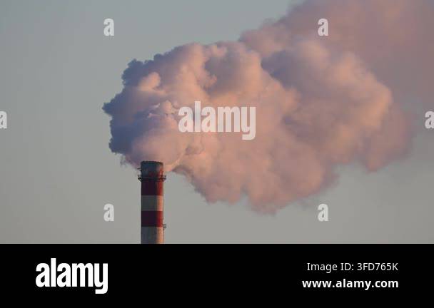 Smoke from factory pipe illuminated by the setting sun, closeup Stock ...