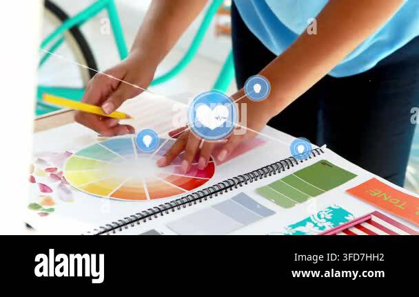 Designer placing hands on swatches and marking wheel, making blue icons ...