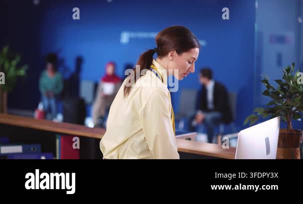 Attractive female security guard working by computer in the airport ...