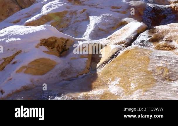 Icy stream and textured sandstone dominate this Red Rock scene in ...
