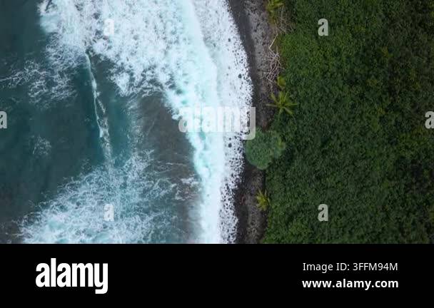 Aerial top down view of turquoise ocean waves breaking into white foam ...